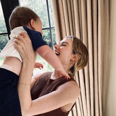 Catlin is holding her baby up.